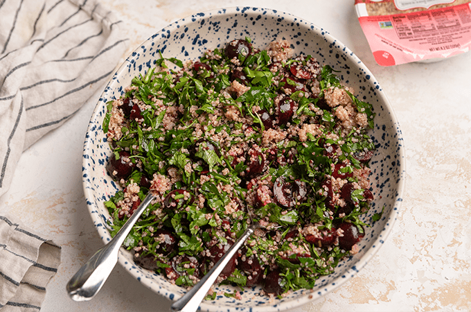 cherry quinoa salad plated with utensils