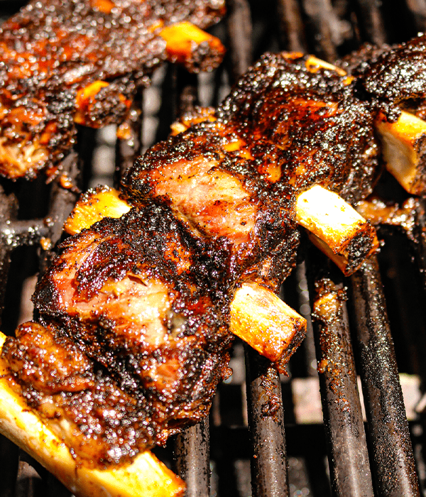 Campfire Coffee-Crusted Beef Ribs on the grill close up view
