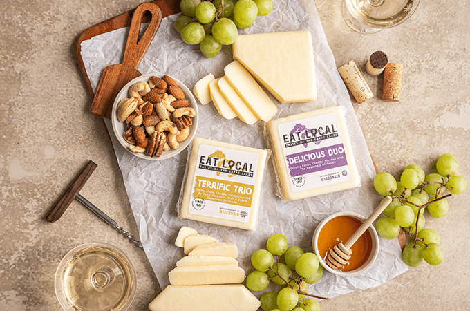 Heinen's selection of Eat Local Cheeses laid out on a table surrounded by snacking parings