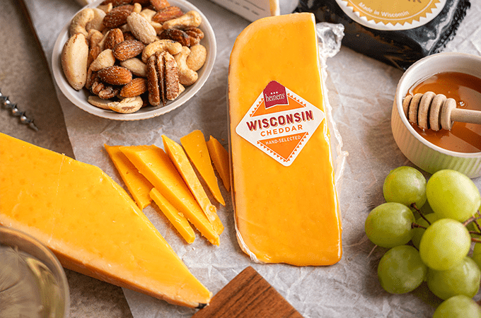 Heinen's Hand-Selected Wisconsin Cheeses laid out on a table surrounded by snacking parings