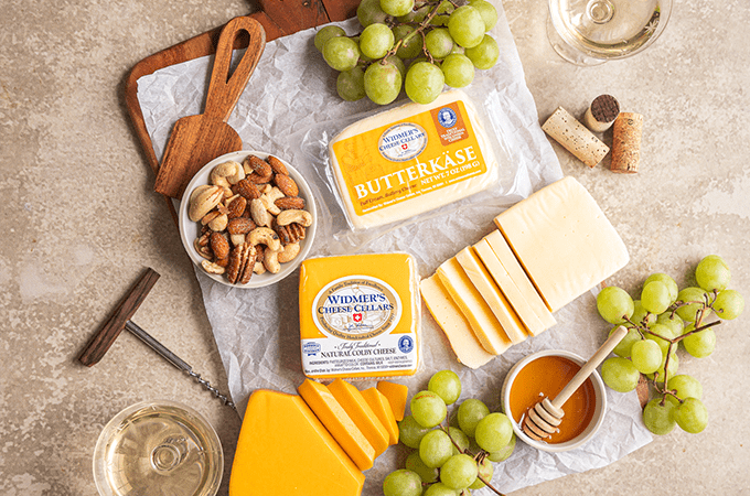 Heinen's selection of Widmer’s Cheeses laid out on a table surrounded by snacking parings