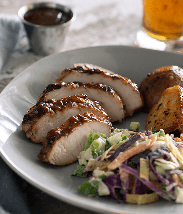 Apricot BBQ Turkey Tenderloin served on a white plate with a side salad