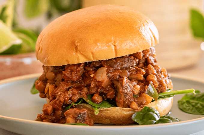 Lentil and Mushroom Sloppy Joe plated with some spinach