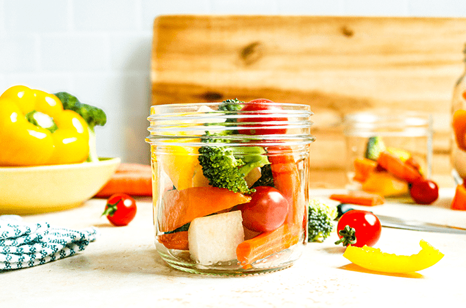 Magic Veggie Jar on a table next to some raw veggies
