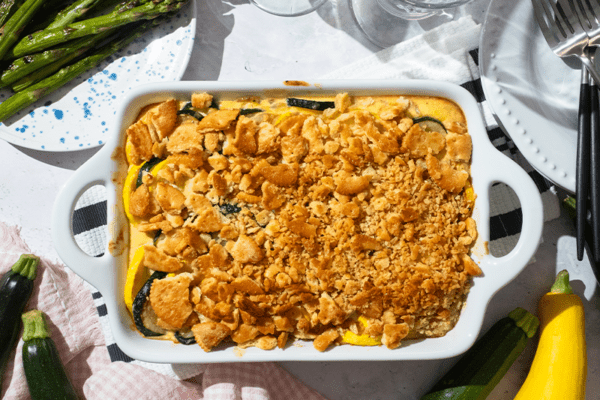 Southern Zucchini Squash Casserole plated with sides of zucchini and asparagus