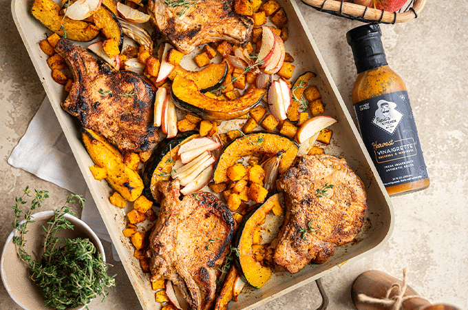 Pan-Seared Pork Chops fresh out of the oven on a table surrounded by its accoutrements