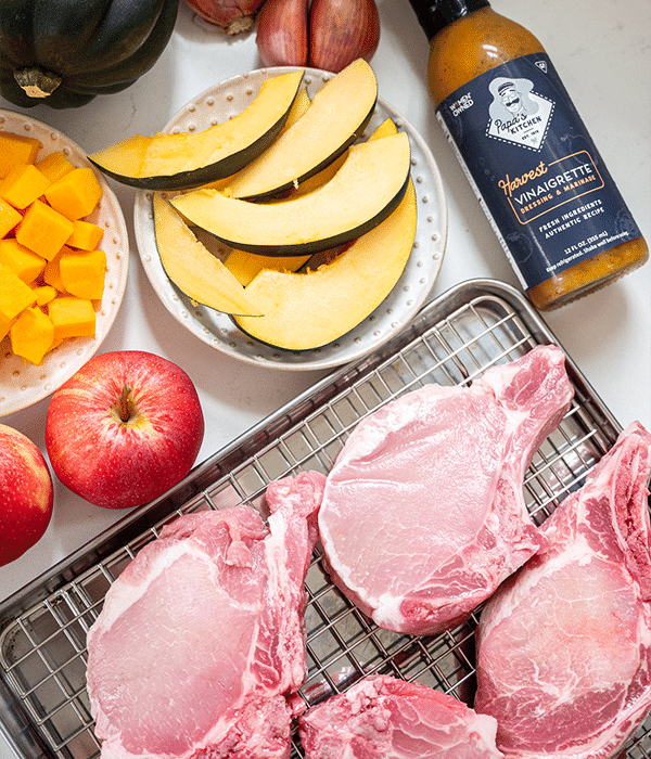 Pan-Seared Pork Chops raw laid out on a wired sheet