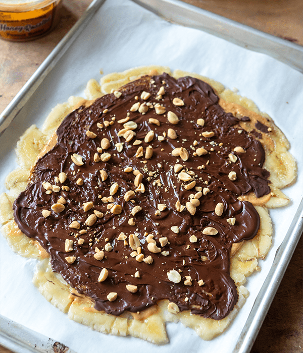 the Peanut Butter Chocolate Banana Bark on parchment paper laid out flat