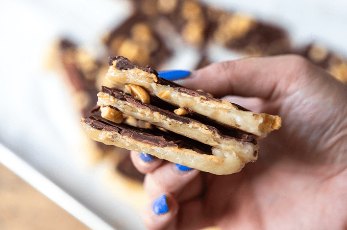 someone holding the Peanut Butter Chocolate Banana Bark with blue nail polish