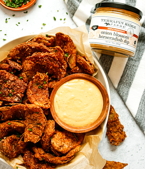 Blooming Onion Petals with Horseradish Dip freshly prepared next to a jar of horseradish dip