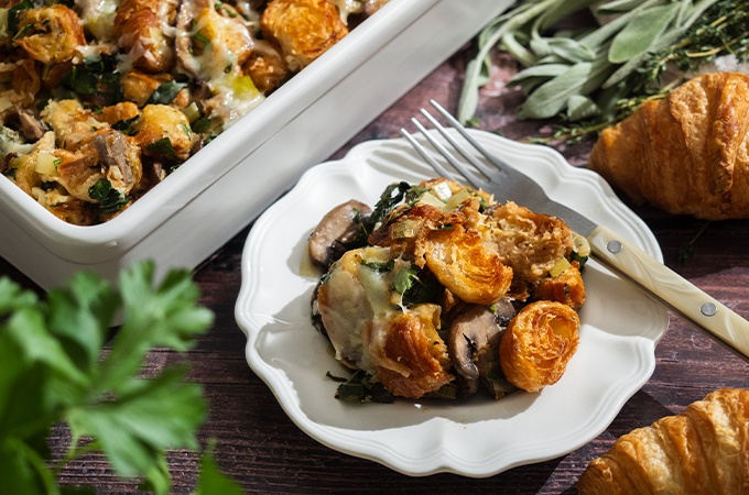 A serving of the Mushroom Croissant Stuffing on a plate with a fork