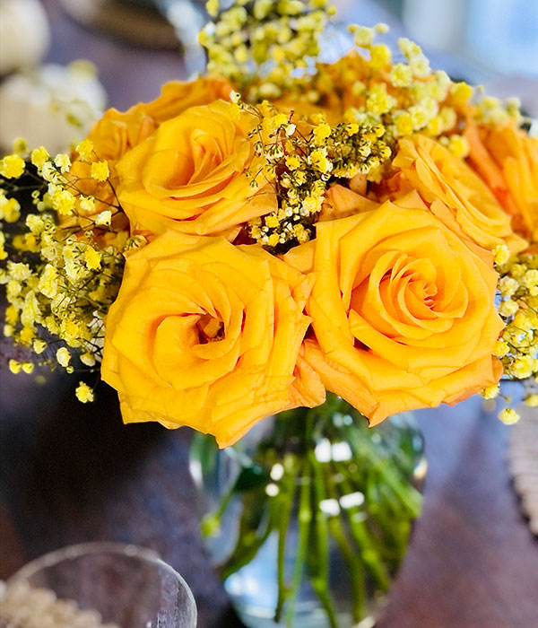 Yellow Roses in a Vase with White Bud Flowers