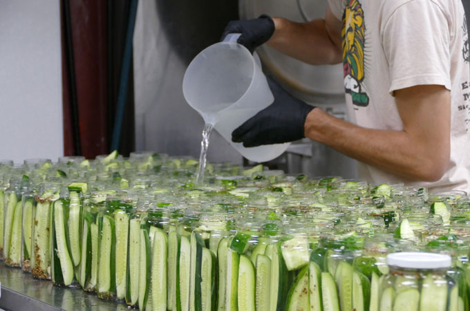 Employee making pickles
