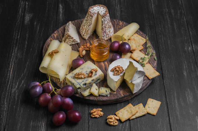 Round cheese board with berries and nuts