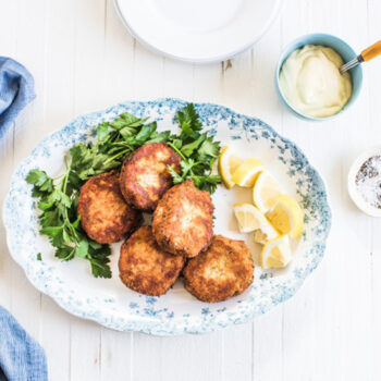 Crab cakes on a plate with lemon slices