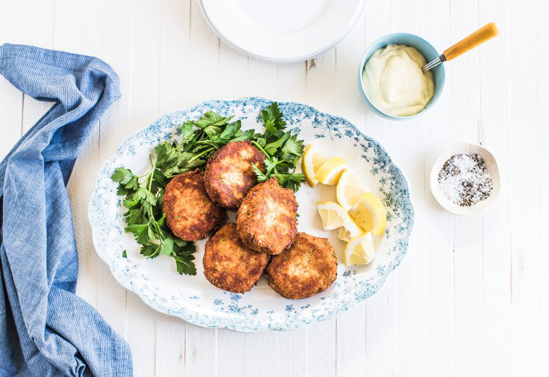 Crab cakes on a plate with lemon slices