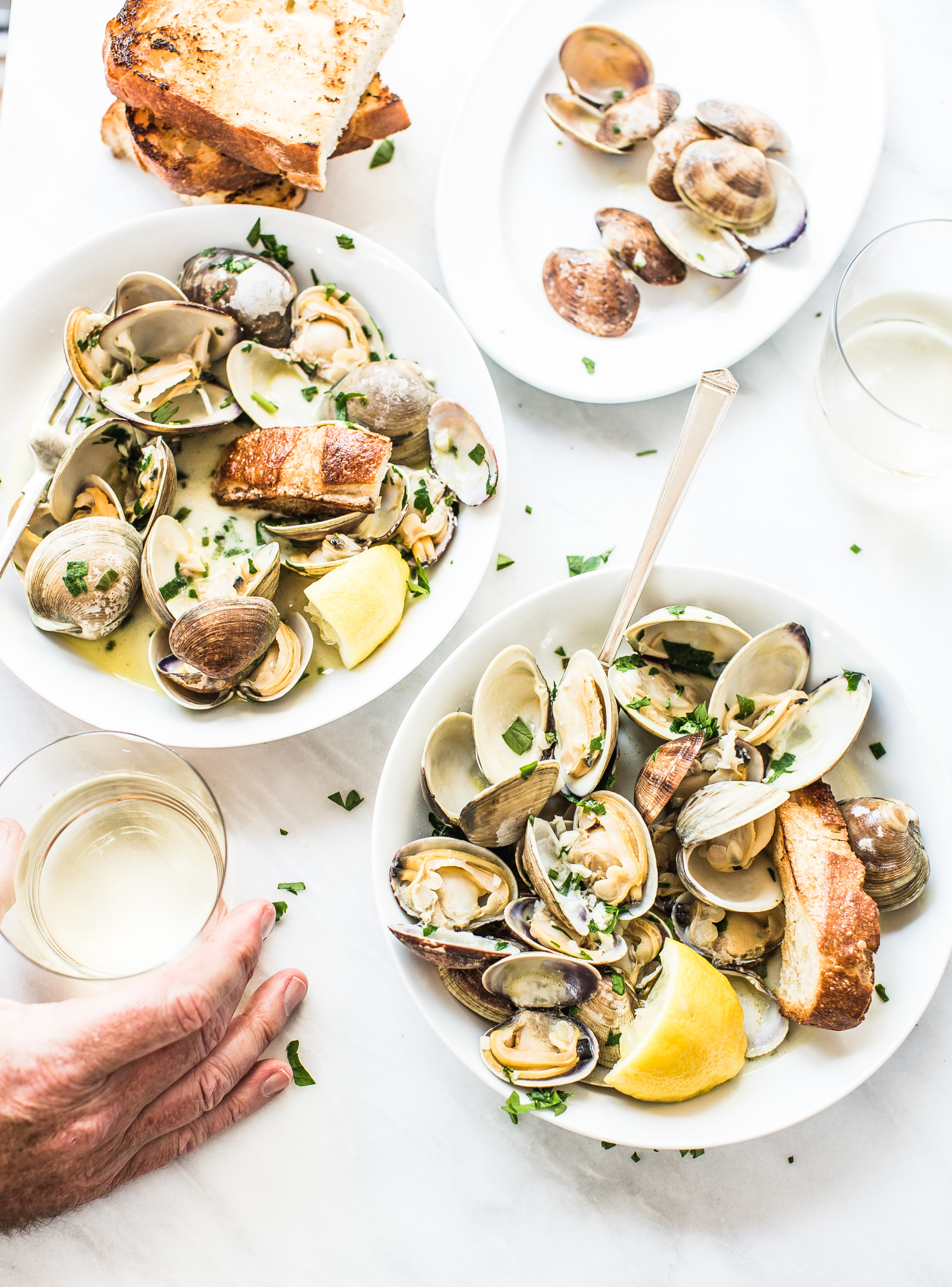 Clams with White Wine Butter and Garlic & glasses of white wine