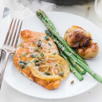 Chicken Piccata with Asparagus on a White Plate