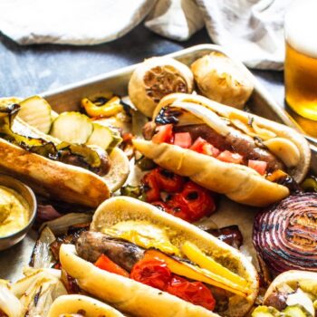 Brats on a Baking Sheet and a Glass of Beer