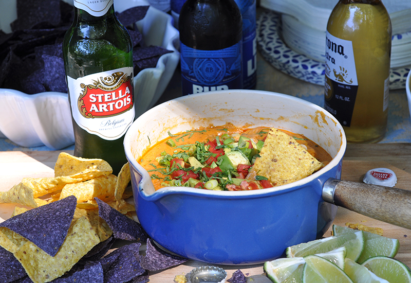 Chili Queso in a Bowl with Different Kinds of Beer