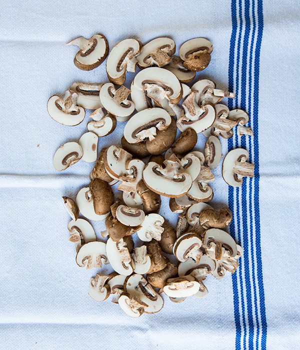 raw, sliced mushrooms on a towel