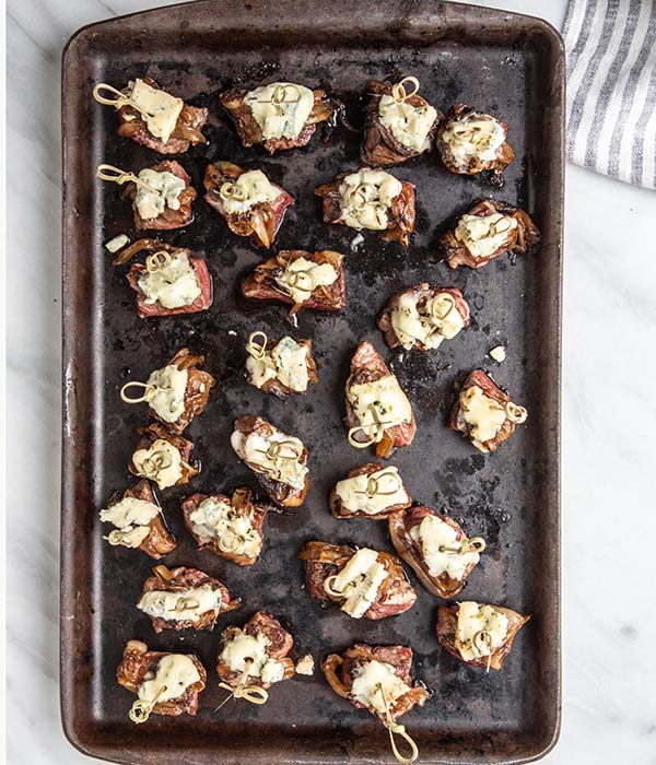 steak bites on a pan with cheese