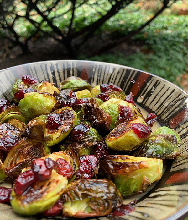 Grilled brussels sprouts in a bowl outside