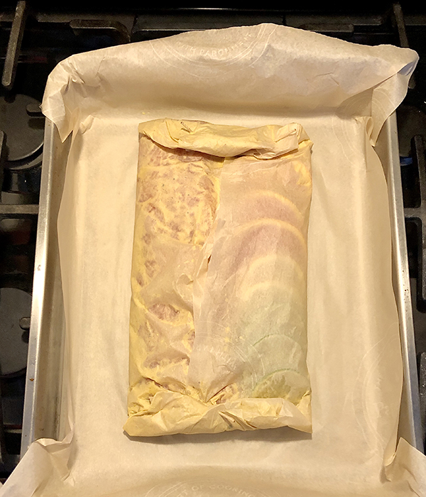 Uncooked citrus salmon in parchment paper