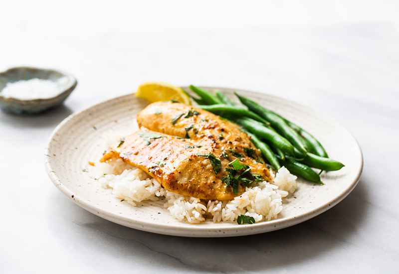 Garlic lemon tilapia served with green beans and white rice