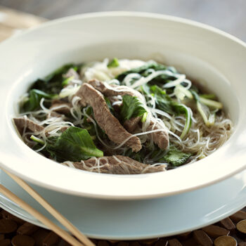 Beef pho in white bowl