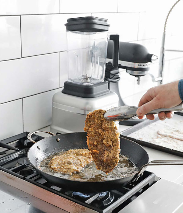 Flipping the chicken fried steak in the pan