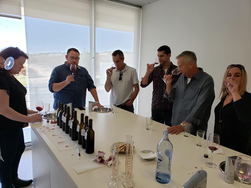 Members of Heinen's Wine Team taste through samples at a winery in Portugal
