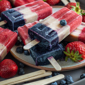Patriotic Popsicles on a Plate with Berries