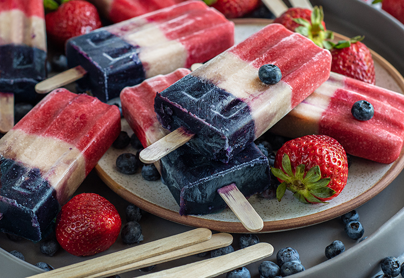 Patriotic Popsicles on a Plate with Berries