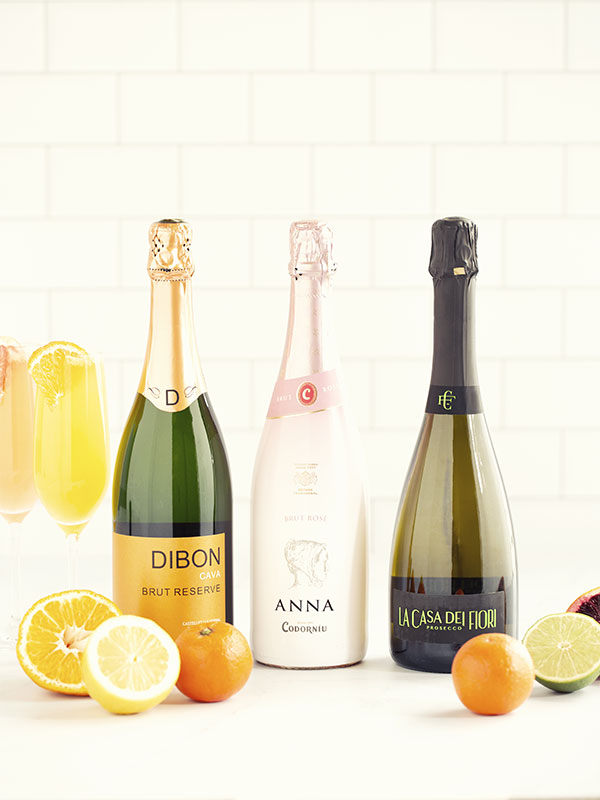 Bottles of Champagne with Grapefruit and Orange Mimosa and Citrus Fruit