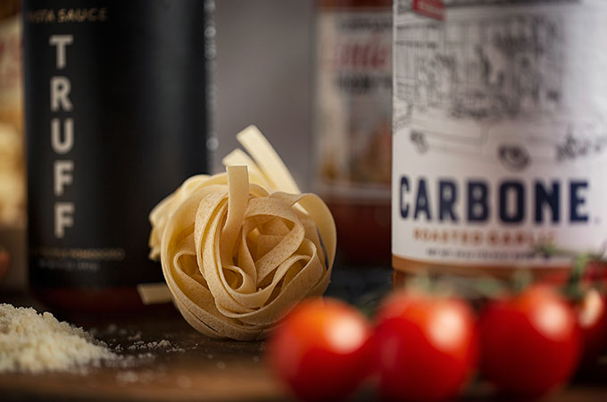 Pasta Sauce Bottle with Fettuccine Nests and Tomatoes