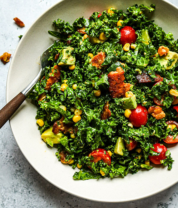 BLT Kale Salad with Tempeh Bacon in a Serving Bowl with a Fork