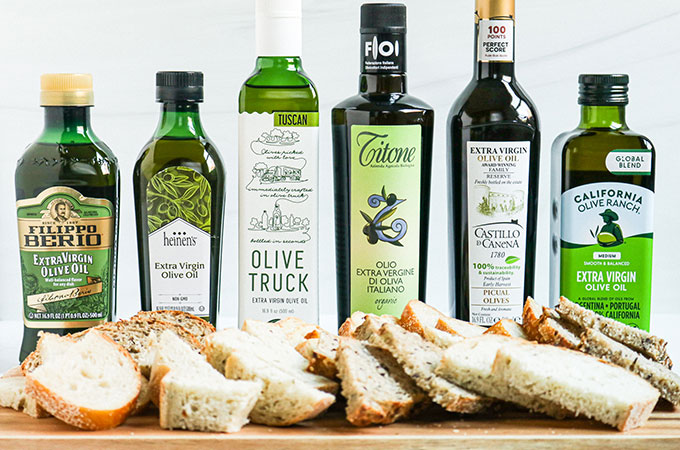 Six Extra Virgin Olive Oil Bottles Carried at Heinen's with Bread Slices