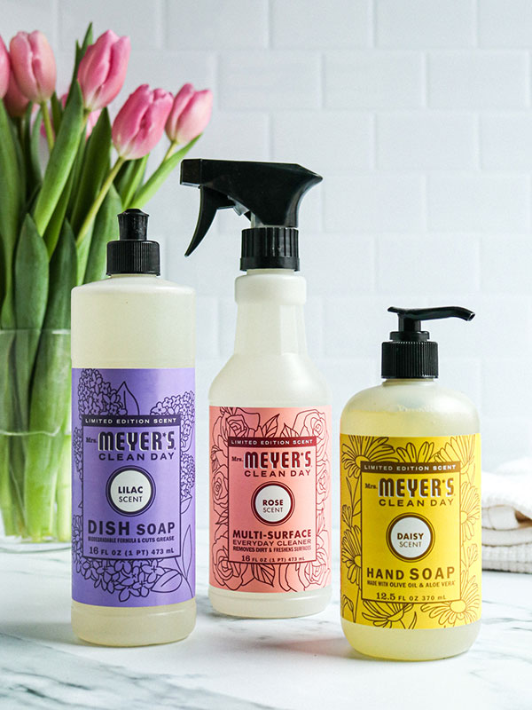 Mrs. Meyers Soaps and Cleaners Beside a Vase of Tulips