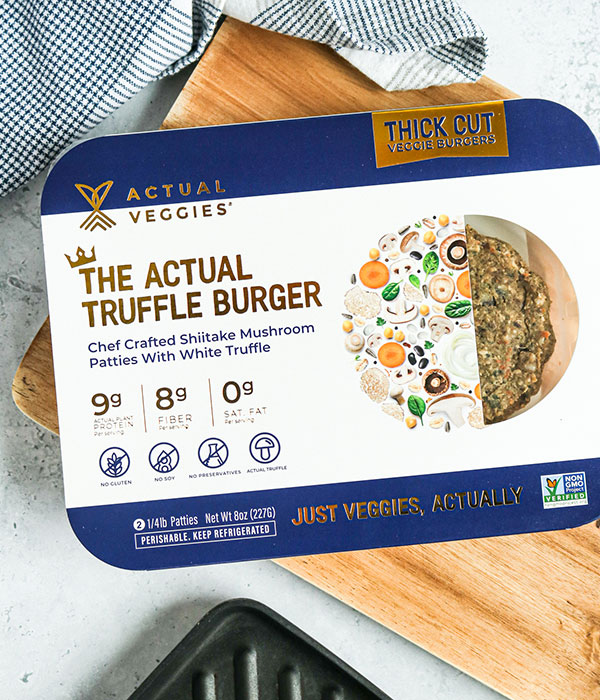 Actual Veggies Veggie Burger in it's packaging on a Wood Cutting Board.