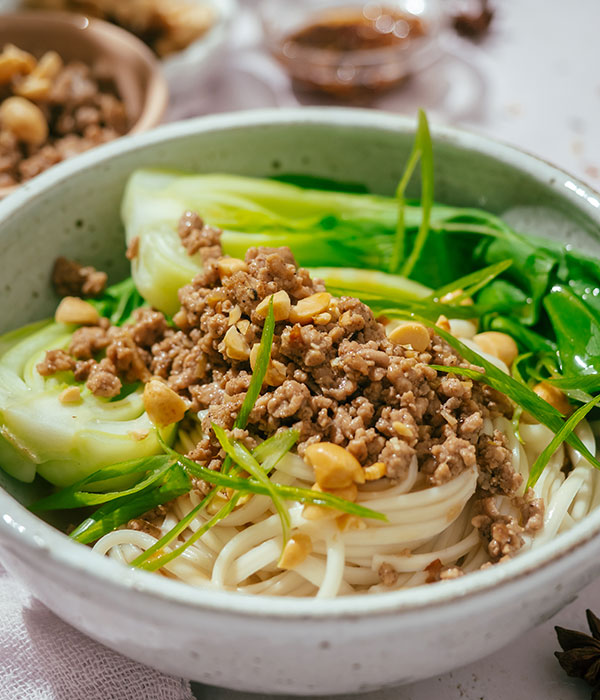 Up-close Photo of Easy Dan Dan Noodle Bowl with Bok Choy and Cooked Pork