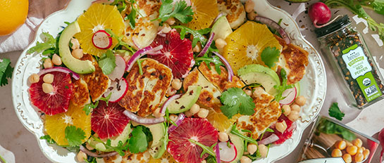 Halloumi Citrus Salad on a Serving Tray with Spices Beside
