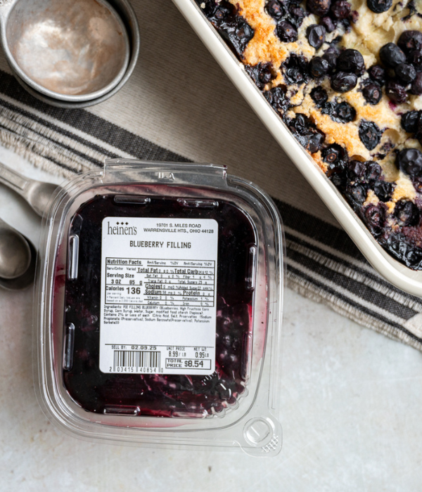 Heinen's Blueberry Pie Filling next to measuring cups and Blueberry Dump Cake Squares.