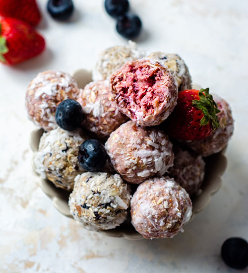 Strawberry and Blueberry Energy Bites with Fresh Strawberries and Blueberries.