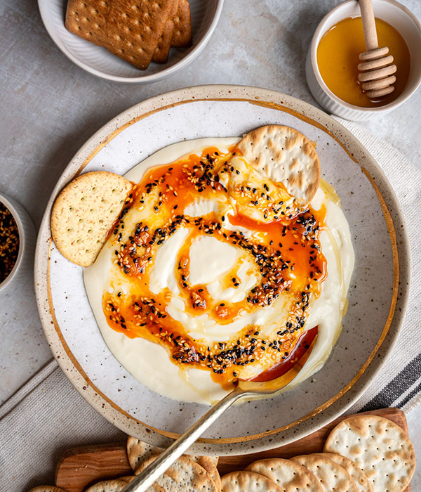 Sweet and Savory Whipped Brie in a Bowl with Crackers and a Bowl of Honey