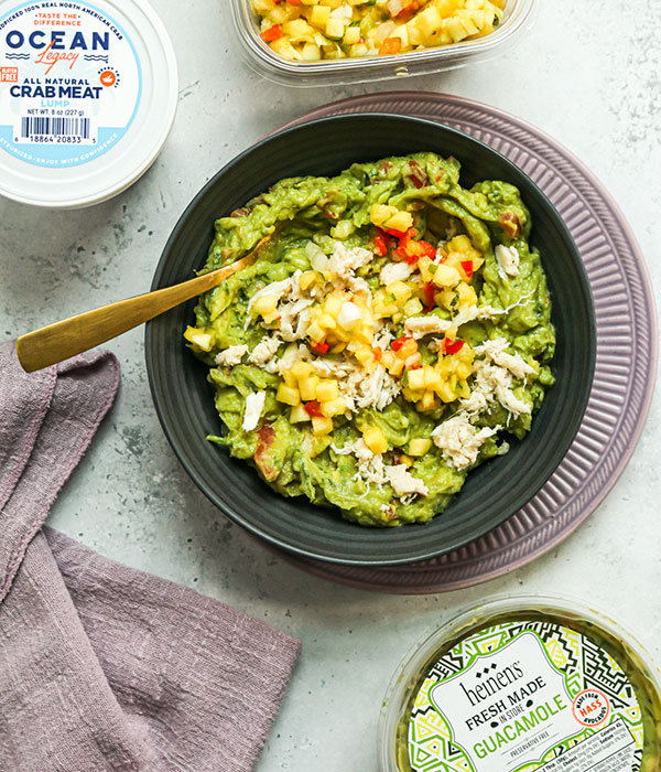 A Bowl of Guacamole with Fresh Crab Meat and Pineapple Mango Salsa on Top