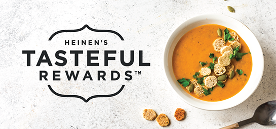 Heinen's Tasteful Rewards Logo on a Stone Background Beside a Bowl of Soup Garnished with Fresh Herbs and Oyster Crackers